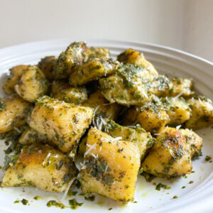A large plate of gnocchi is made with acorn squash and tossed with basil pesto for an autumnal version of this classic Italian dish.
