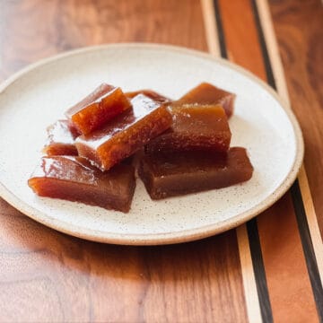 A speckled plate holds approximately 8 rectangular slices of guava paste.