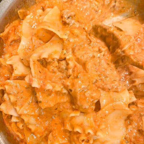 A pot of pasta that is lasagna soup. The lasagna noodles are broken up and coated in creamy tomato sauce and cheese.