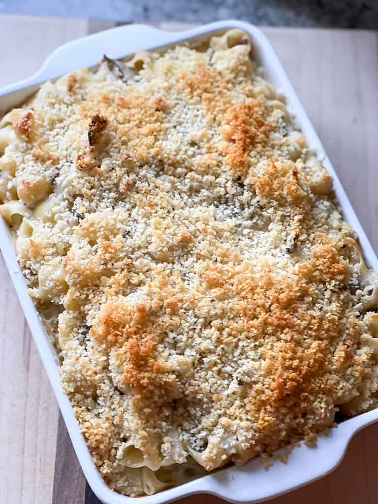 Baking dish with golden brown crust of truffle mac and cheese. 