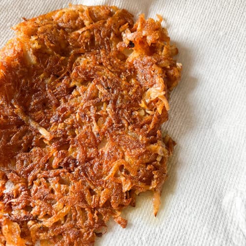 Crispy harissa spiced hashbrowns plated on a lined paper towels.