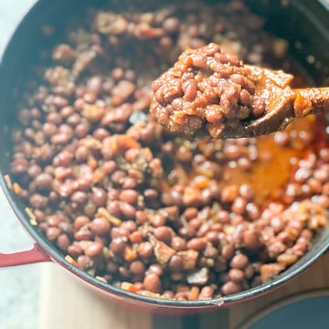 A large dutch oven holds a big batch of stewed Santa maria-Style Pinquito Beans.
