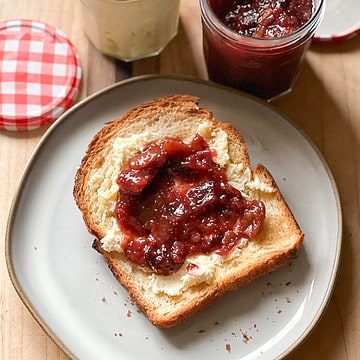 A slice of brioche toast is slathered with clotted cream and Freezer Friendly Refrigerator Homemade Fig Jam Recipe.