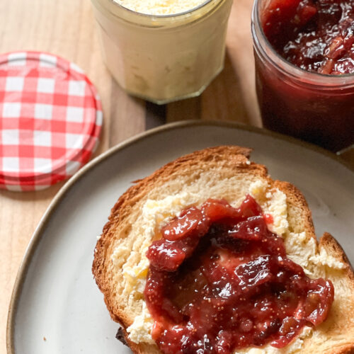 A slice of brioche toast is slathered with clotted cream and Freezer Friendly Refrigerator Homemade Fig Jam Recipe.
