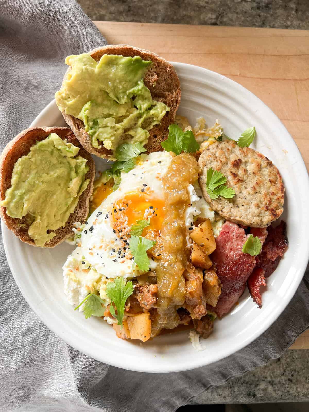 Cottage cheese with lemon juice on a plate with eggs and english muffins.
