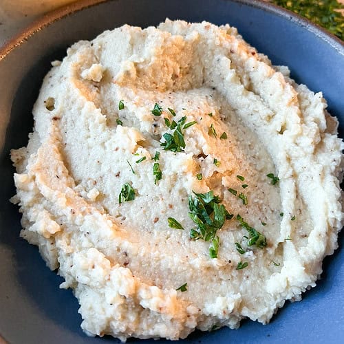 Flatlay photo of Roast Cauliflower Puree Garnished with Chopped Fresh Parsley.