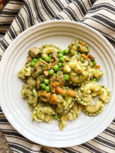 Flatlay photo of the finished dish of Carrot Top Pesto with Sauteed Peas and Carrots.