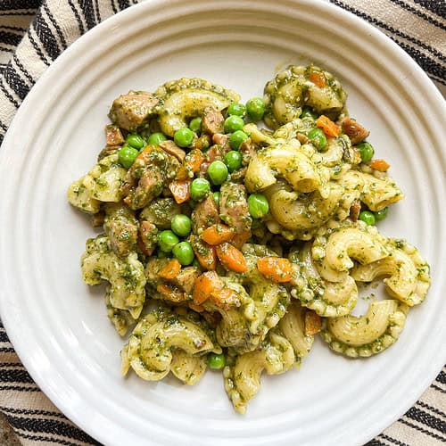 Flatlay photo of the finished dish of Carrot Top Pesto with Sauteed Peas and Carrots.