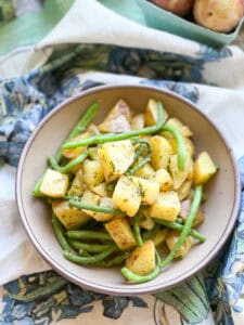 Flatlay photo of the finished side dish for Sauteed New Potatoes & Green Beans with Sorrel Butter.