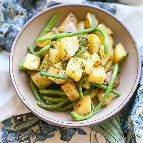 Flatlay photo of the finished side dish for Sauteed New Potatoes & Green Beans with Sorrel Butter.