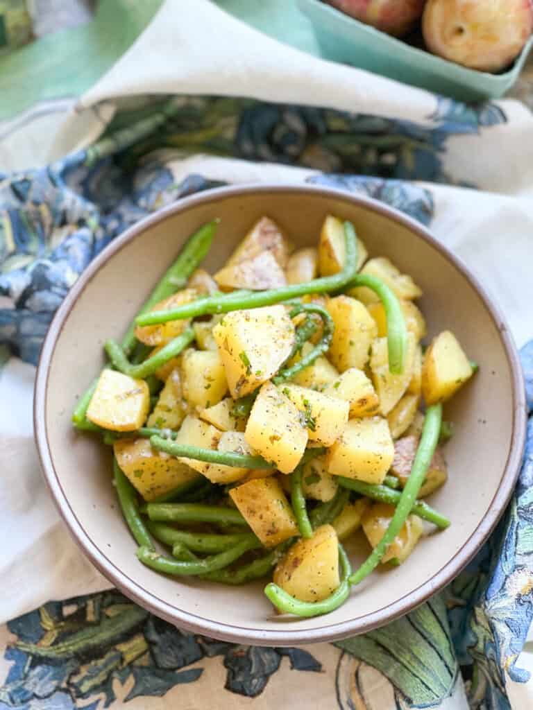 Flatlay photo of the finished side dish for Sauteed New Potatoes & Green Beans with Sorrel Butter. 