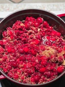 Picture of nearly finished Pomegranate Cranberry Sauce with Bourbon Recipe in a large dutch oven.