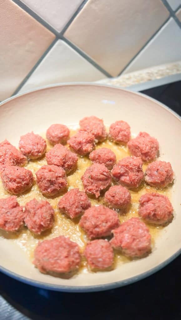Meatballs in the braiser pan frying up for the One Pan Orzo recipe. 
