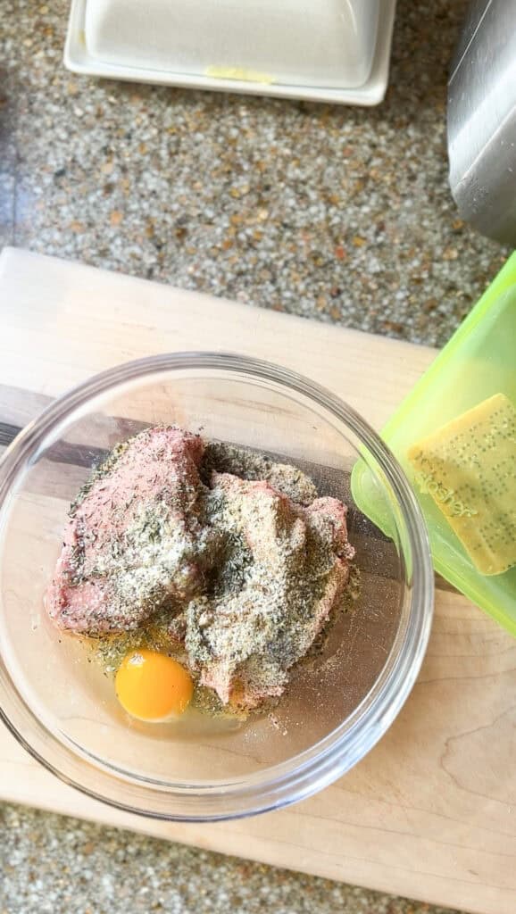 Meatball prep featuring ground chicken, egg, and all recipe listed seasonings. 