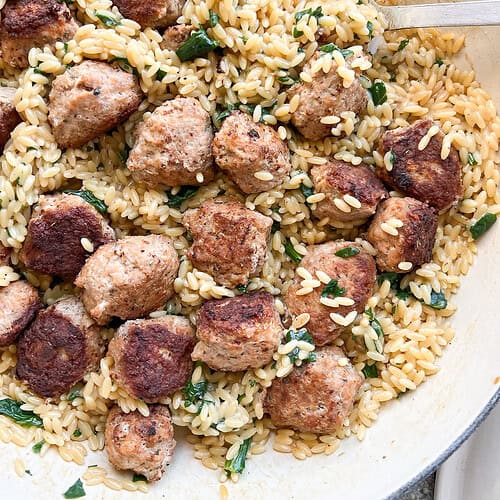 overhead image of the finished One Pan Orzo with Pesto and Herby Chicken Meatballs