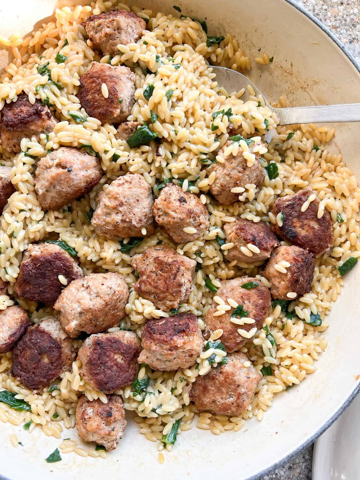 overhead image of the finished One Pan Orzo with Pesto and Herby Chicken Meatballs